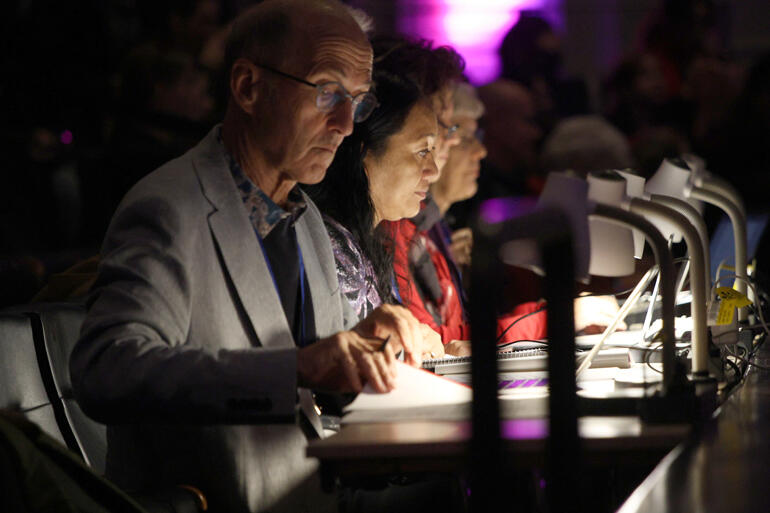 Holy Trinity Cathedral Director of Choirs Peter Watts works on The Big Sing adjudicators' panel at Finale 2025.