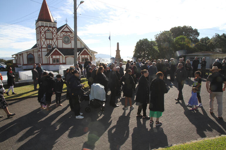 People gather as the morning sun streams over St Faith's historic church before Bishop Ngarahu's celebration of ministry at Papaiouru marae.