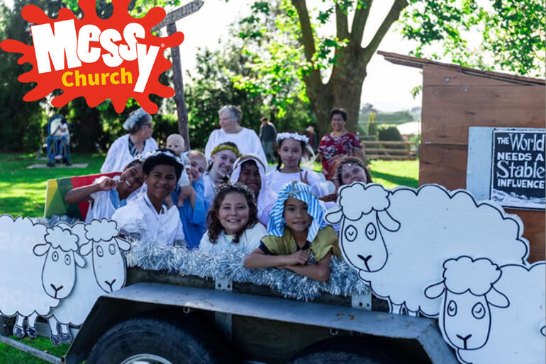 Children jump into the Christmas trailer for a photo with the nativity sheep at Messy Church at St Paul's Putaruru.