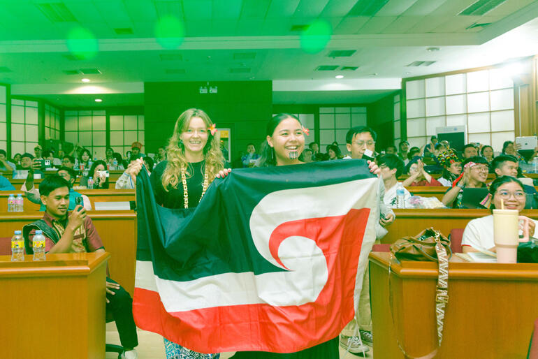 Hannah Corbett and Shinaya Kaiwai walk through delegates at the AEYA in Chiang Mai.